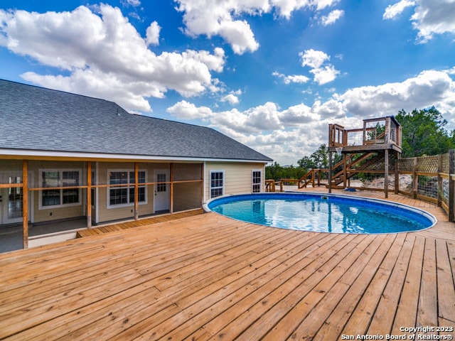 view of swimming pool featuring a wooden deck