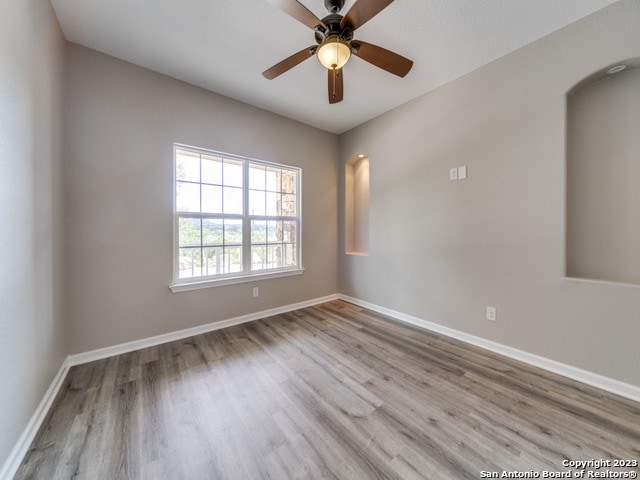 unfurnished room featuring ceiling fan and light hardwood / wood-style floors