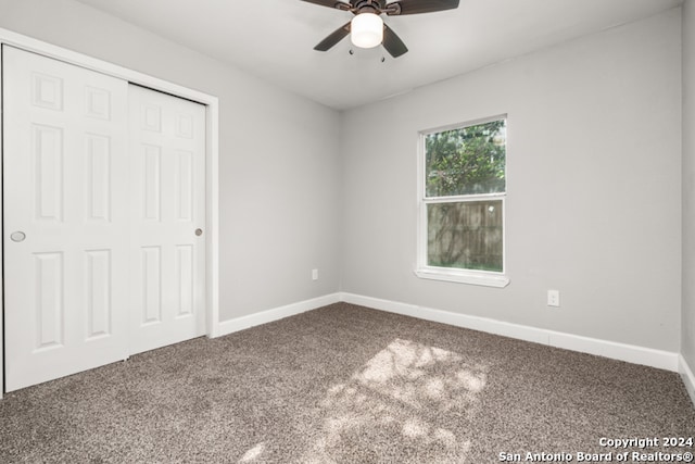 unfurnished bedroom featuring a closet, carpet, and ceiling fan