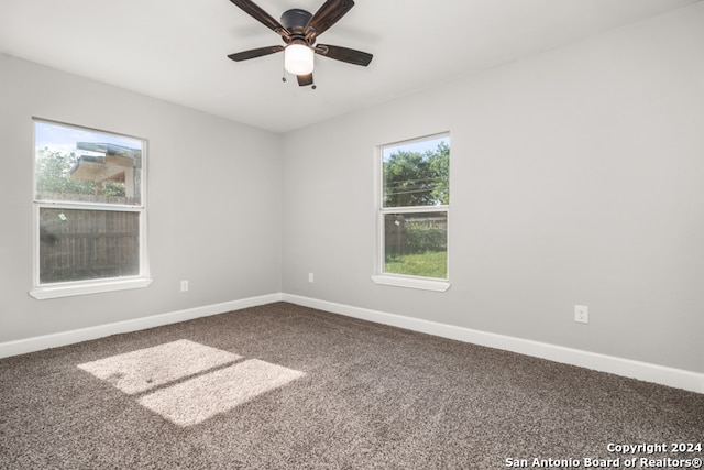 carpeted spare room with ceiling fan