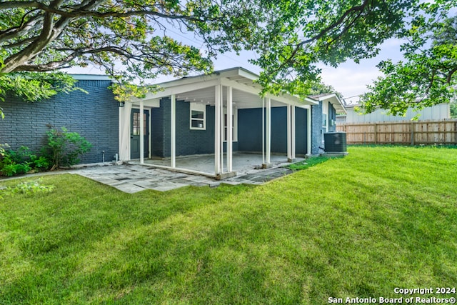 exterior space with cooling unit and a yard