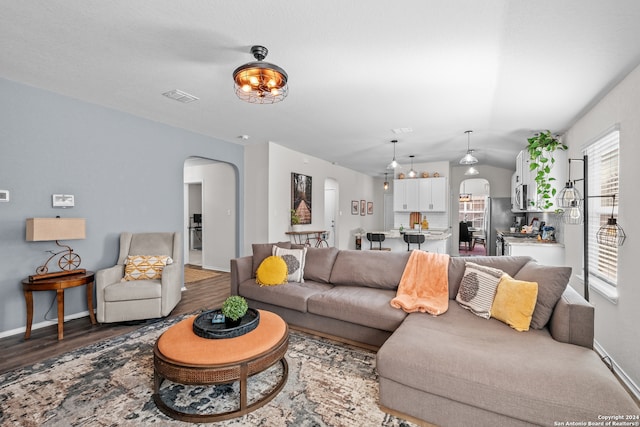 living room featuring vaulted ceiling and hardwood / wood-style floors