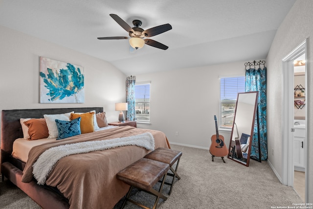 carpeted bedroom with vaulted ceiling, sink, and ceiling fan