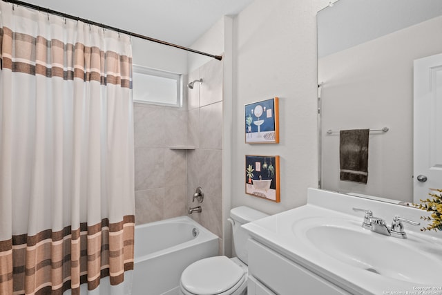 full bathroom featuring shower / tub combo with curtain, vanity, and toilet