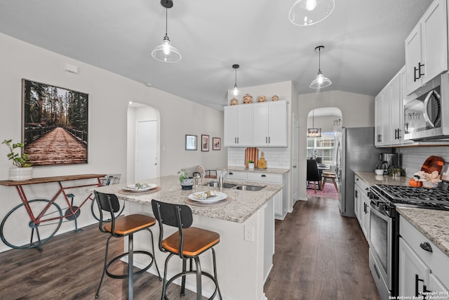 kitchen with a center island with sink, appliances with stainless steel finishes, sink, and white cabinetry