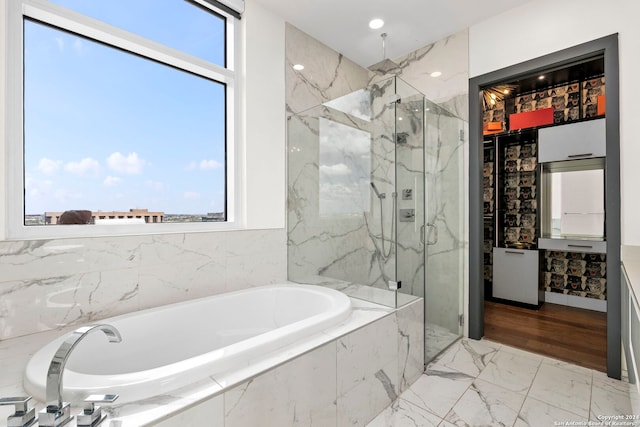 bathroom with vanity, separate shower and tub, and a healthy amount of sunlight