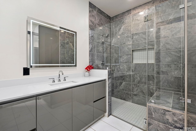 bathroom featuring vanity, a shower with door, and tile patterned floors