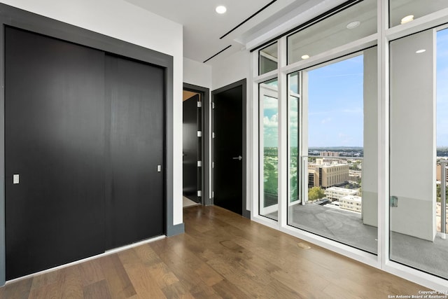 interior space with wood-type flooring, access to outside, and expansive windows