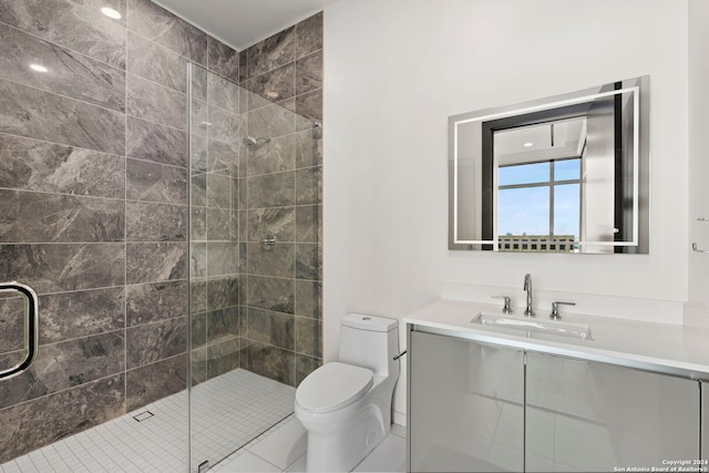 bathroom featuring tile patterned flooring, a shower with door, vanity, and toilet