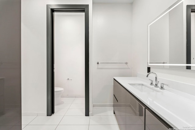 bathroom with tile patterned flooring, vanity, and toilet