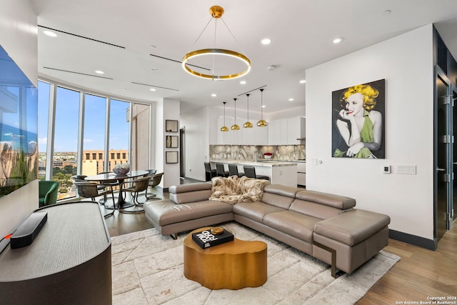 living room featuring a chandelier and light hardwood / wood-style floors