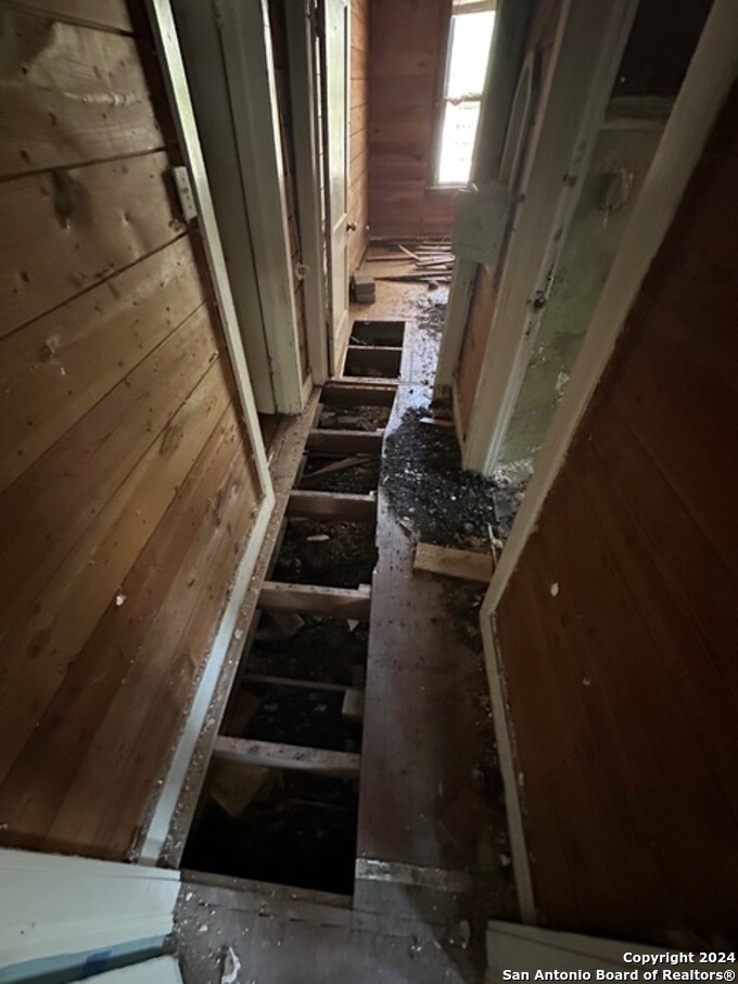 335 Elmhurst Ave, San Antonio, TX 78209 - hallway featuring wood walls