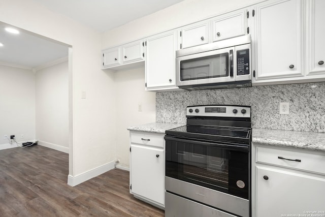 kitchen with appliances with stainless steel finishes, dark wood-type flooring, light stone counters, tasteful backsplash, and white cabinets