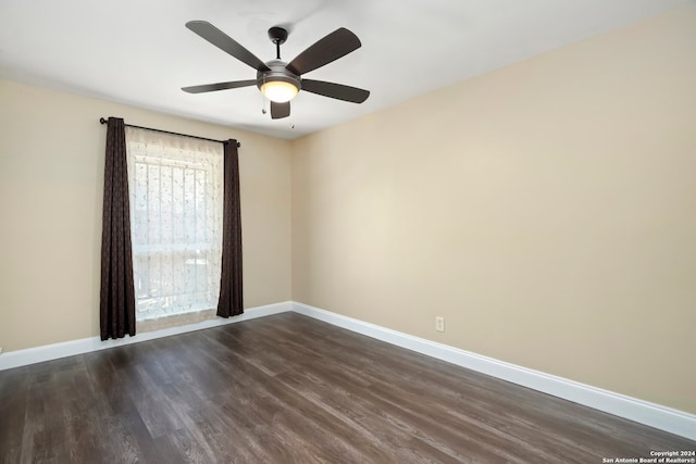 empty room featuring dark hardwood / wood-style flooring and ceiling fan