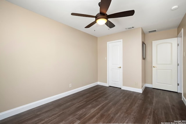 unfurnished bedroom featuring ceiling fan and dark hardwood / wood-style flooring