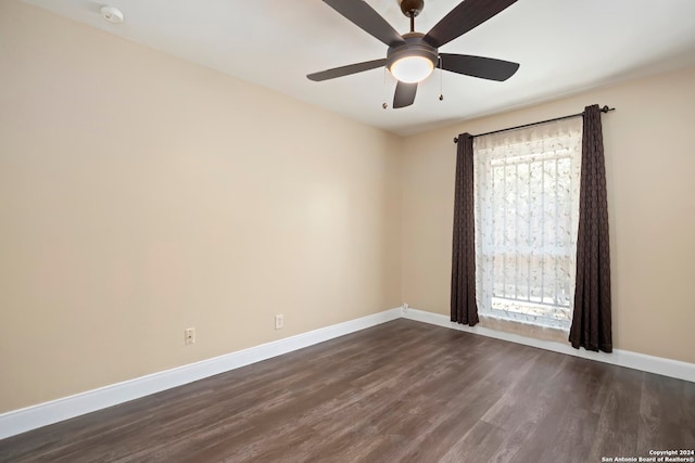 spare room with dark hardwood / wood-style floors, ceiling fan, and plenty of natural light