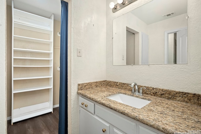 bathroom featuring vanity and hardwood / wood-style flooring