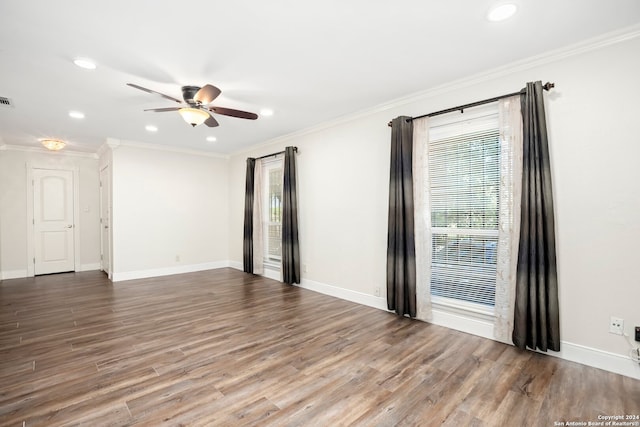 empty room featuring ceiling fan, hardwood / wood-style flooring, and crown molding