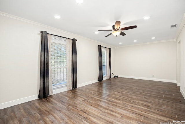 empty room with ceiling fan, crown molding, and dark hardwood / wood-style flooring