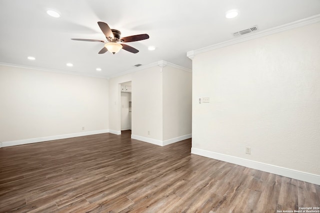 spare room featuring ceiling fan, dark hardwood / wood-style floors, and crown molding