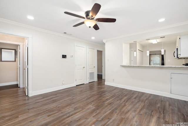 unfurnished living room with ceiling fan, ornamental molding, and dark hardwood / wood-style flooring