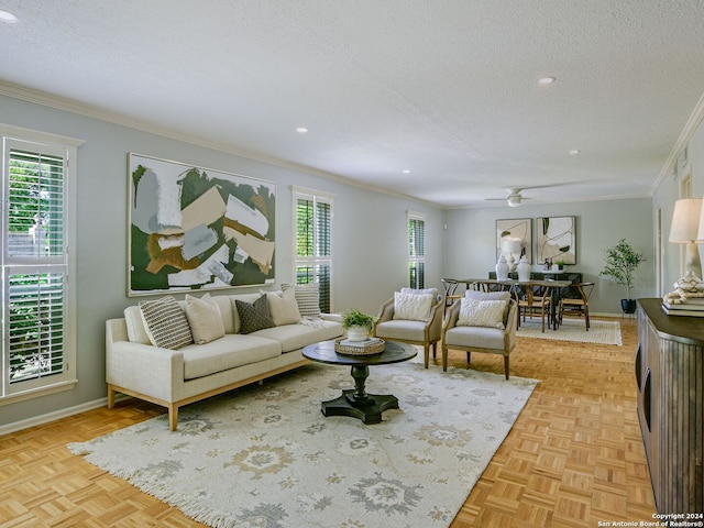 living room with crown molding, light parquet flooring, and a textured ceiling