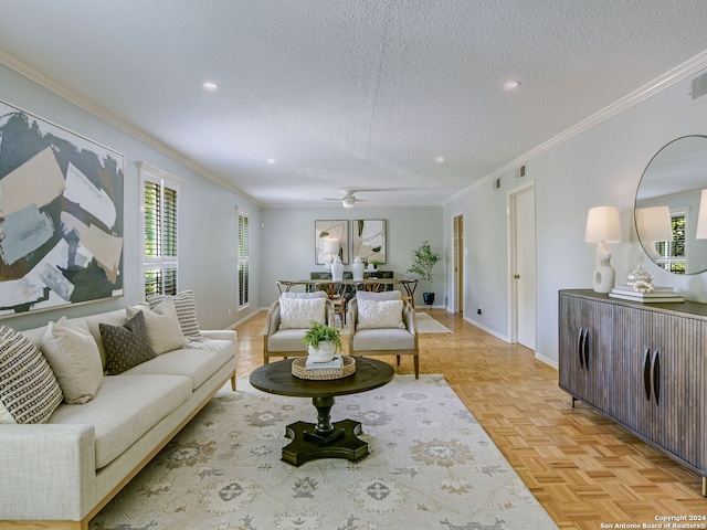 living room featuring ceiling fan, crown molding, a textured ceiling, and light parquet floors