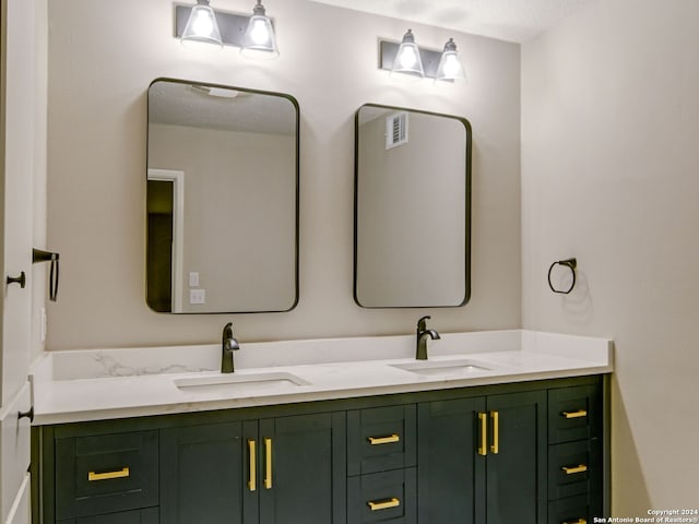 bathroom with vanity and a textured ceiling