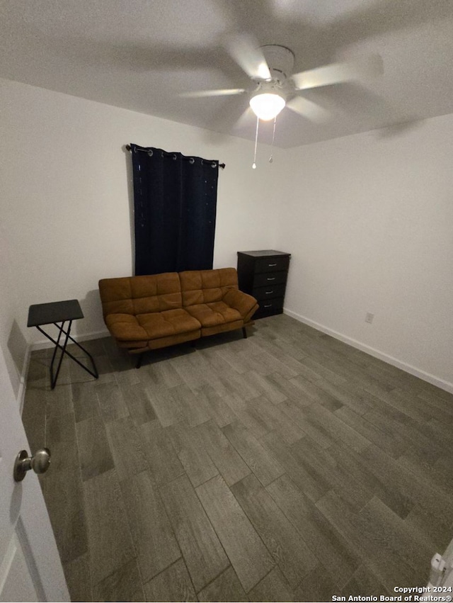 unfurnished living room featuring ceiling fan, wood-type flooring, and a textured ceiling