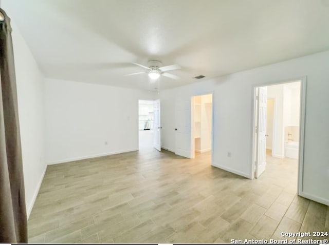 unfurnished room featuring ceiling fan and light wood-type flooring