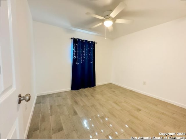 unfurnished room featuring ceiling fan and light wood-type flooring