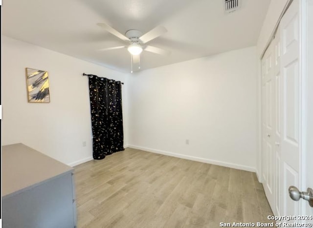 empty room featuring ceiling fan and light hardwood / wood-style floors