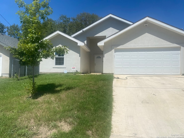 ranch-style home featuring a front lawn and a garage