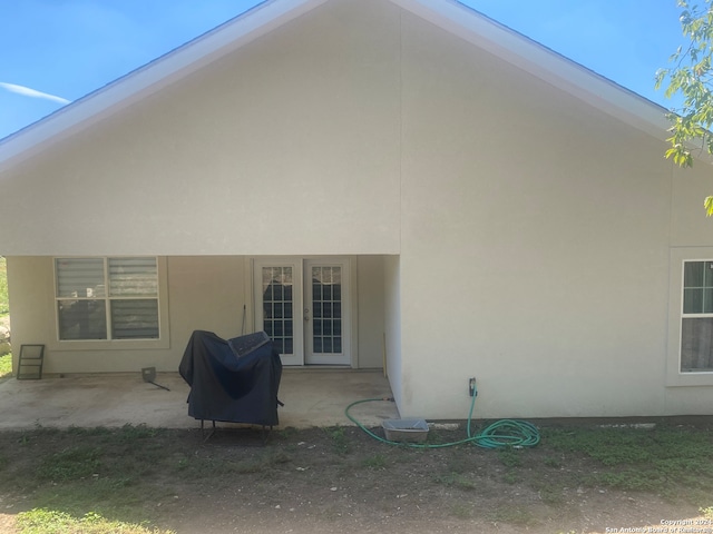 back of property with french doors and a patio