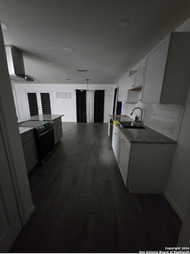 kitchen with electric range, sink, dark hardwood / wood-style floors, extractor fan, and white cabinets