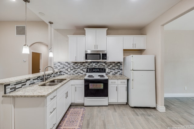 kitchen with white cabinets, decorative light fixtures, sink, and white appliances