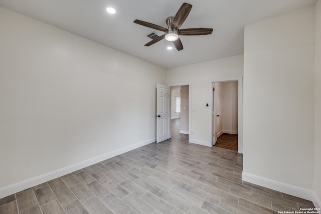 empty room featuring ceiling fan and light hardwood / wood-style flooring