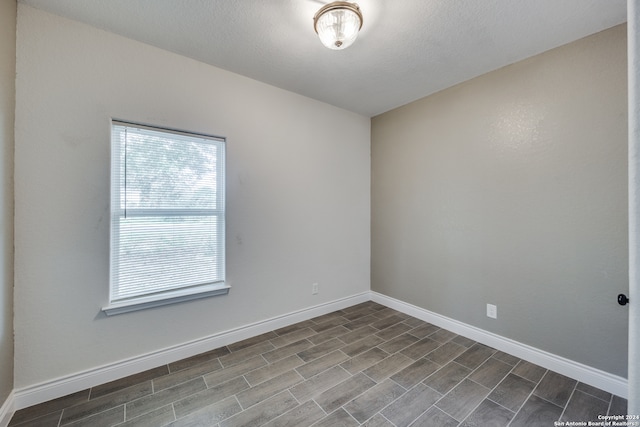 unfurnished room with hardwood / wood-style floors