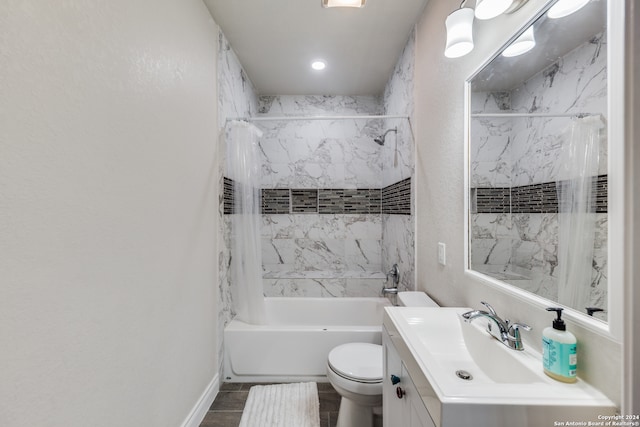 full bathroom featuring tile patterned flooring, vanity, toilet, and tiled shower / bath