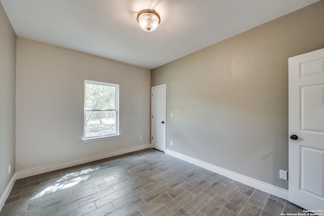 spare room with hardwood / wood-style floors