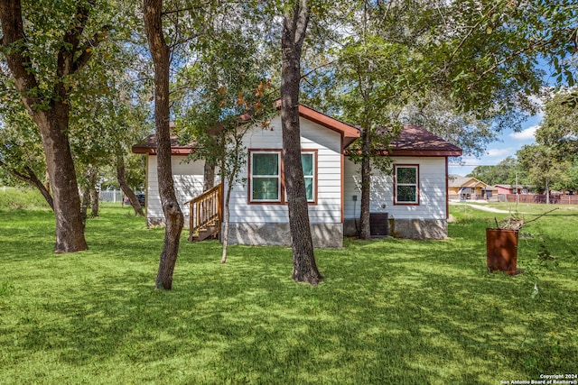 rear view of property with a yard