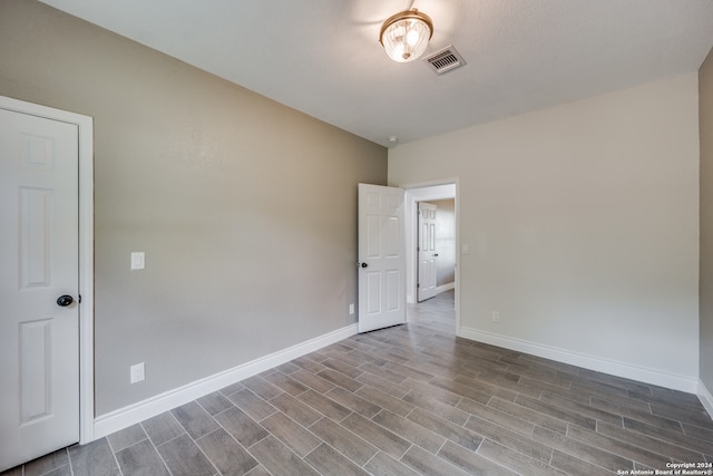 spare room featuring wood-type flooring