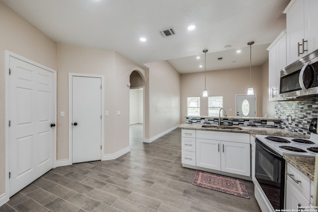 kitchen with white cabinetry, white range with electric cooktop, hanging light fixtures, and sink