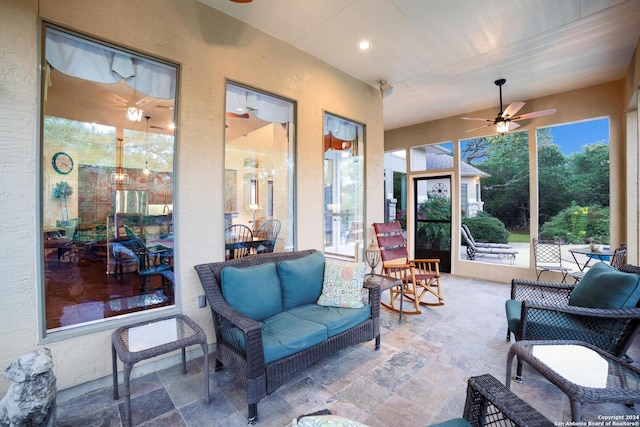 sunroom / solarium with a textured wall and stone finish flooring