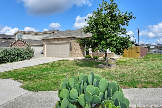 view of front of home with a front yard and a garage