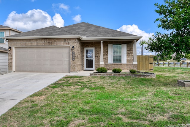 view of front of home with a garage and a front lawn