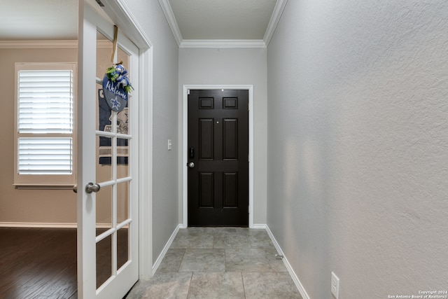 entryway featuring ornamental molding and light hardwood / wood-style floors