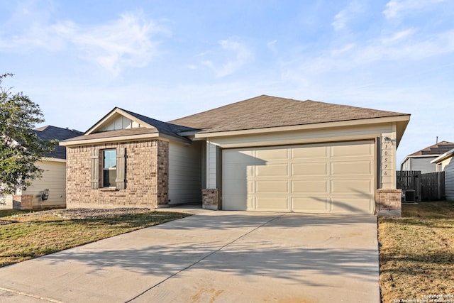 single story home featuring a garage and a front lawn