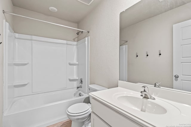 full bathroom featuring toilet, vanity, and washtub / shower combination