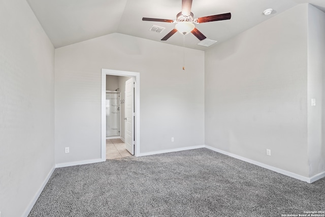 carpeted empty room featuring ceiling fan and lofted ceiling